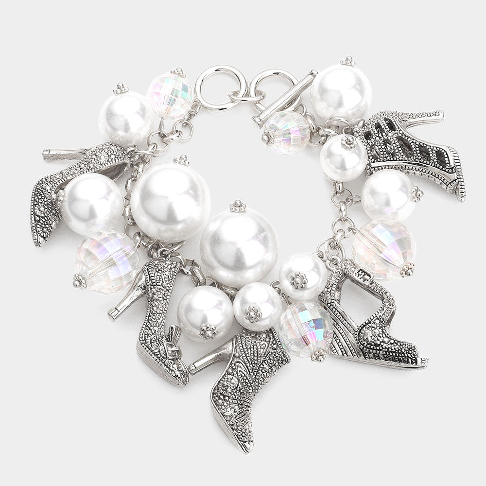 Silver Bracelet with white pearls and high-heeled shoe charms on a white background