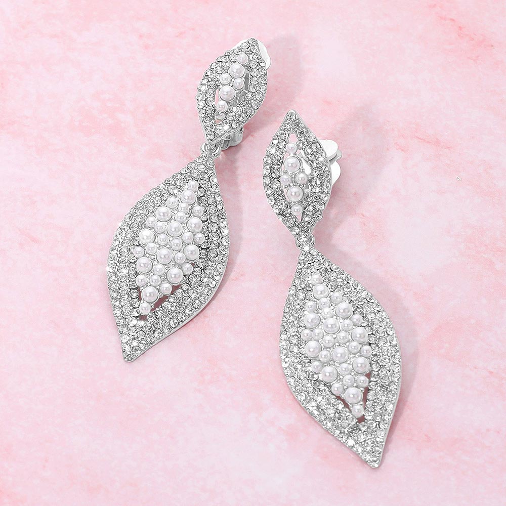 White Pearl & Crystal Marquise Clip On Earrings on a pink background