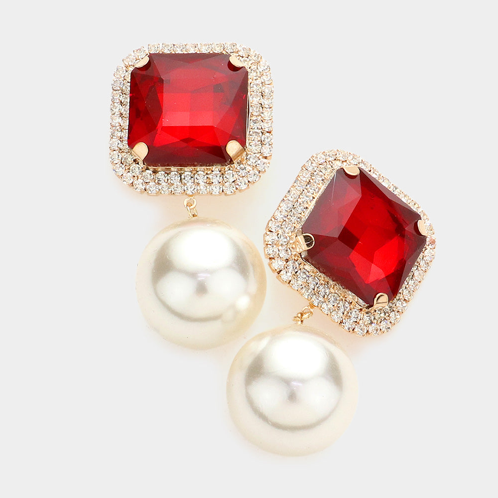 Red square stone cream pearl link dangle clip-on earrings with gold-tone setting on a light gray background