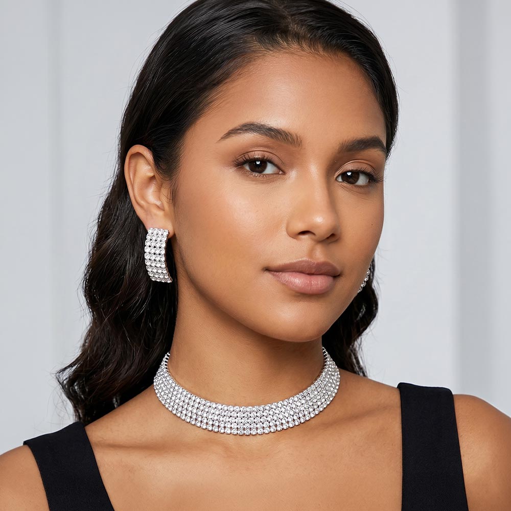 Model wearing 5-row silver backed clear rhinestone choker with matching earrings shown here on a blurred white background. 