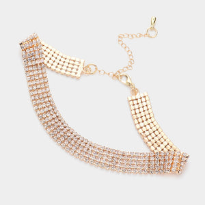 A 5 row gold-tone choker necklace with multiple rows of clear rhinestones, featuring a mesh-like chain design, adjustable lobster clasp, and extender chain on a light gray background.