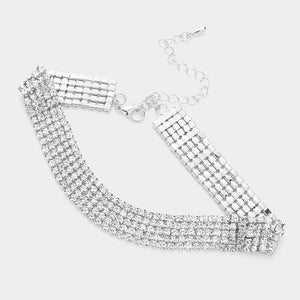 A silver-toned rhinestone choker necklace with multiple rows of clear crystals, a lobster clasp, and an adjustable chain extender, displayed on a light gray background.