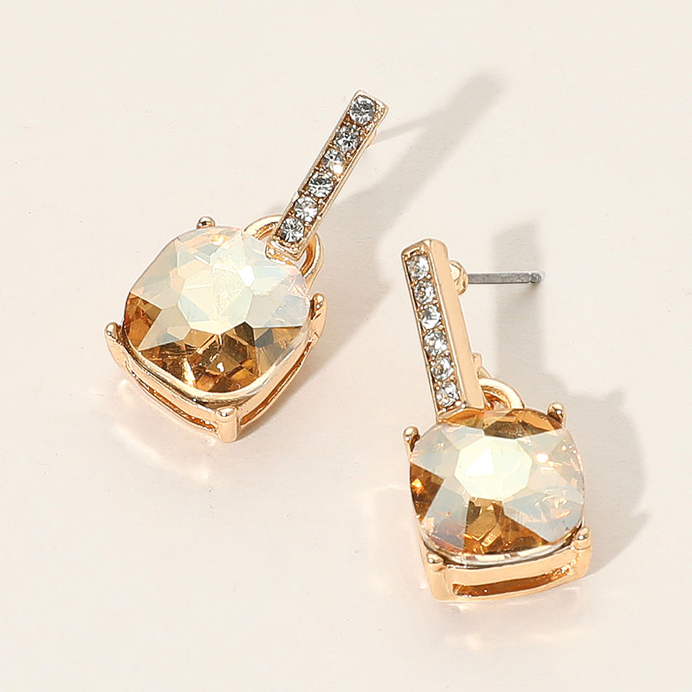 Champagne Gold Stone crystal cushion square dangle earrings on gold with a large cushion-cut stone suspended from a narrow crystal-lined bar, displayed on a white background.