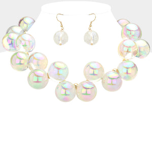 Chunky clear on gold iridescent balls/spheres necklace with matching earrings on a white background