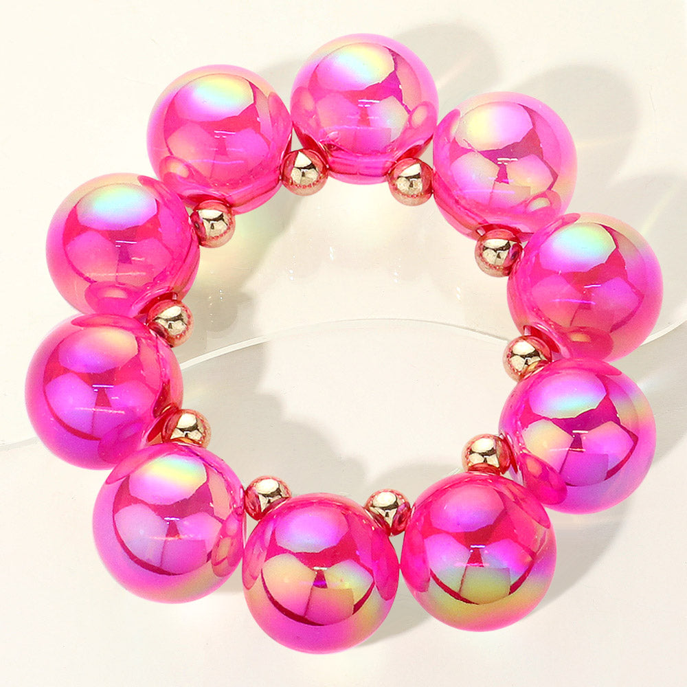 Chunky fuchsia iridescent balls/spheres bracelet on a white background