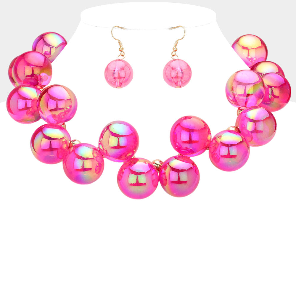Chunky fuchsia iridescent balls/spheres necklace with matching earrings on a white background