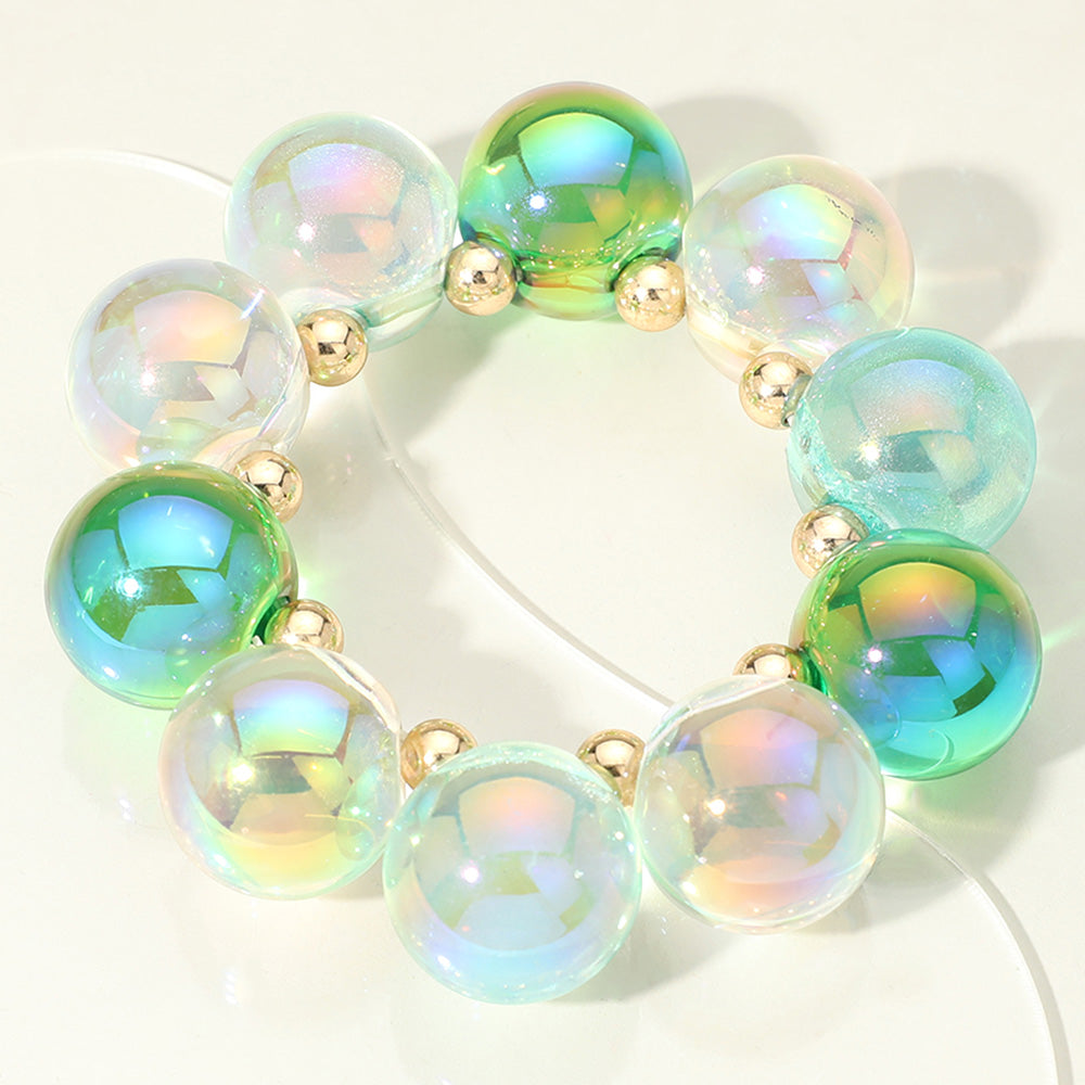 Chunky green and clear iridescent balls/spheres bracelet on a white background