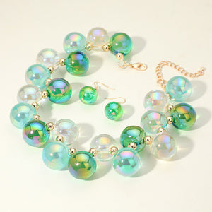 Chunky green, mint & clear iridescent balls/spheres necklace with matching earrings on a white background