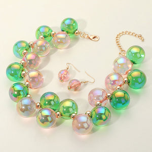 Chunky green iridescent balls/spheres necklace with matching earrings on a white background