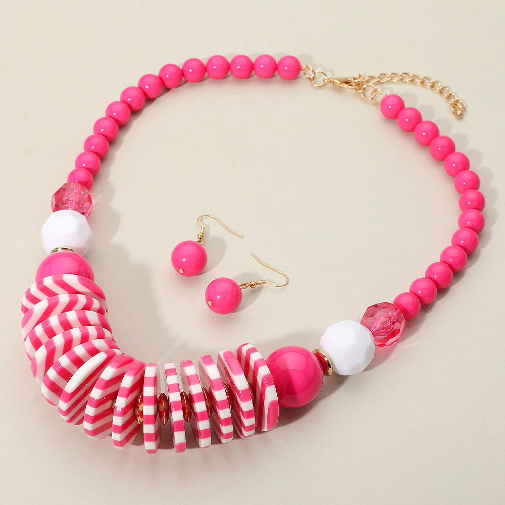 Chunky Hot Pink and White Striped Resin Beaded Neklace with matching earrings on a cream background