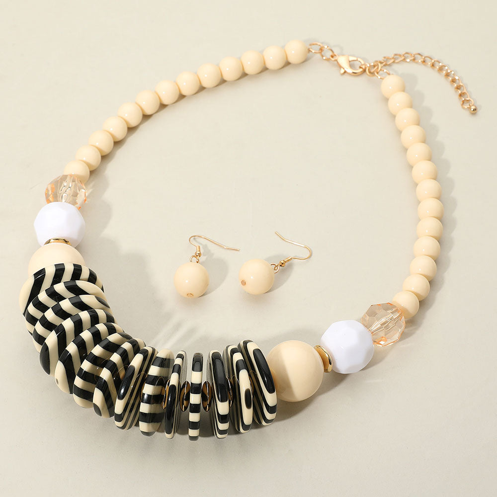 Chunky Ivory and Striped Resin Beaded Neklace with matching earrings on a cream background