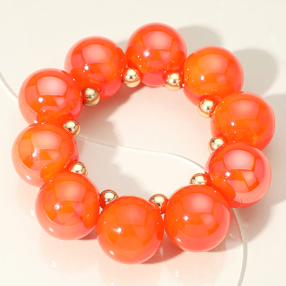 Chunky orange iridescent balls/spheres bracelet on a white background
