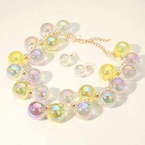 Chunky yellow & clear iridescent balls/spheres necklace with matching earrings on a white background