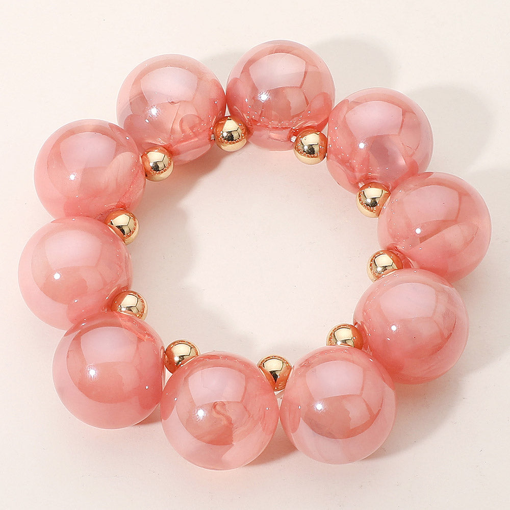 Chunky pink iridescent balls/spheres bracelet on a white background