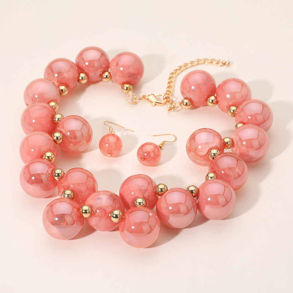 Chunky pink iridescent balls/spheres necklace with matching earrings on a white background