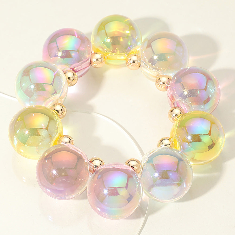 Chunky pink and clear iridescent balls/spheres bracelet on a white background