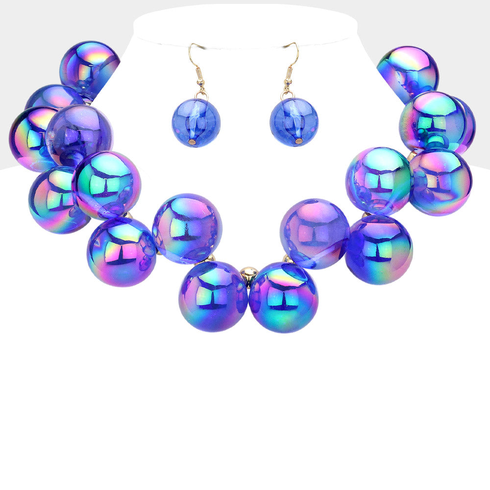 Chunky royal blue iridescent balls/spheres necklace with matching earrings on a white background