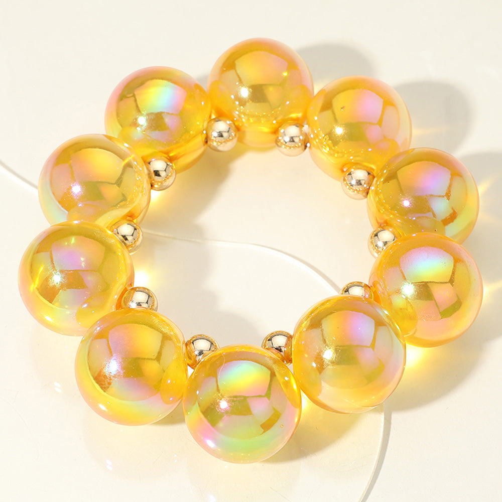 Chunky yellow iridescent balls/spheres bracelet on a white background