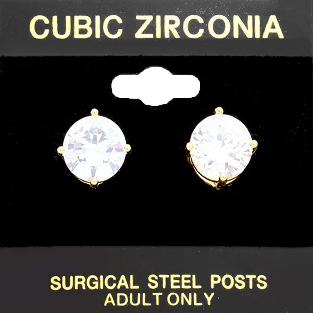 Classic round clear crystal stud earrings in a gold finish with four-prong settings and surgical steel posts, displayed on a black jewelry card.