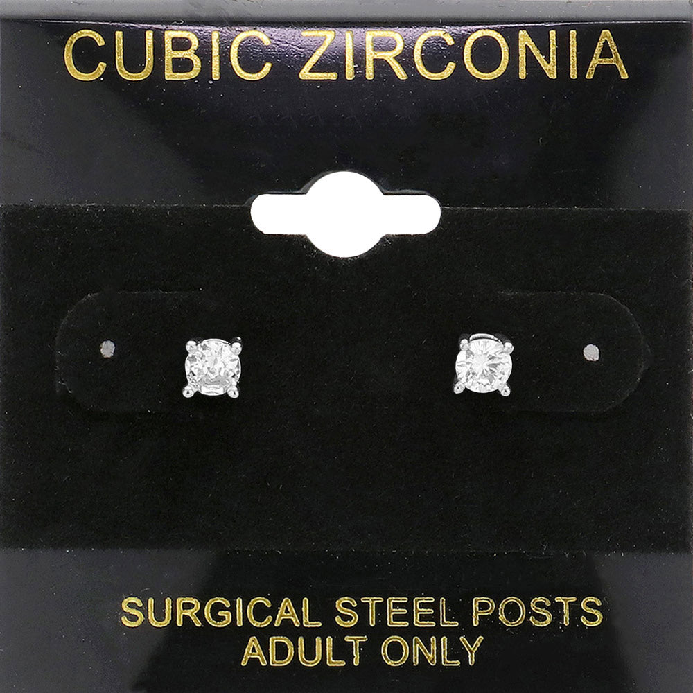 Classic round clear crystal stud earrings in a silver finish with prong settings and surgical steel posts, displayed on a black jewelry card.