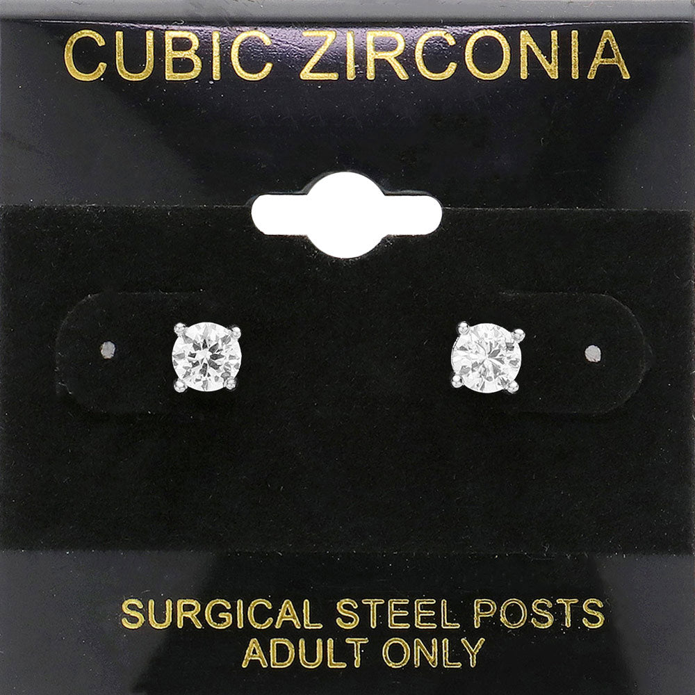 Classic round clear crystal stud earrings in a silver finish with prong settings and surgical steel posts, displayed on a black jewelry card.