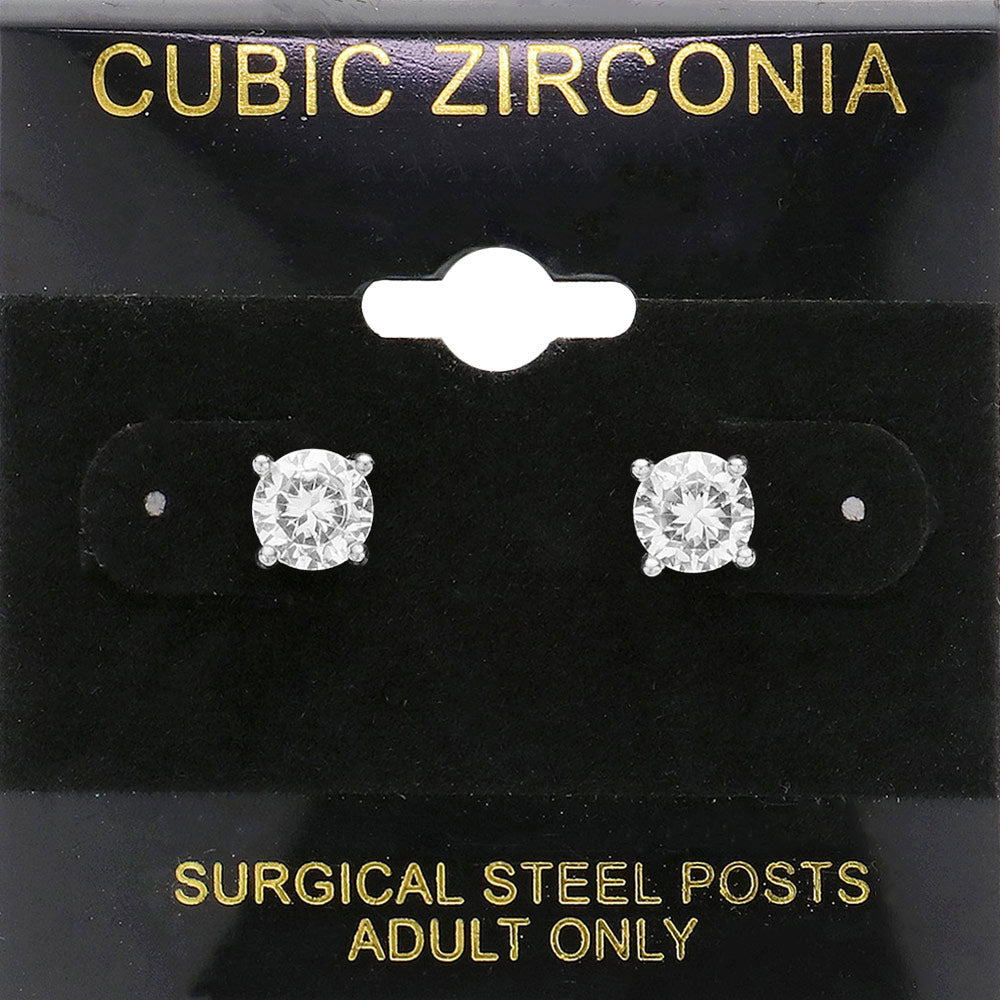 Classic round clear crystal stud earrings in a silver finish with prong settings and surgical steel posts, displayed on a black jewelry card.