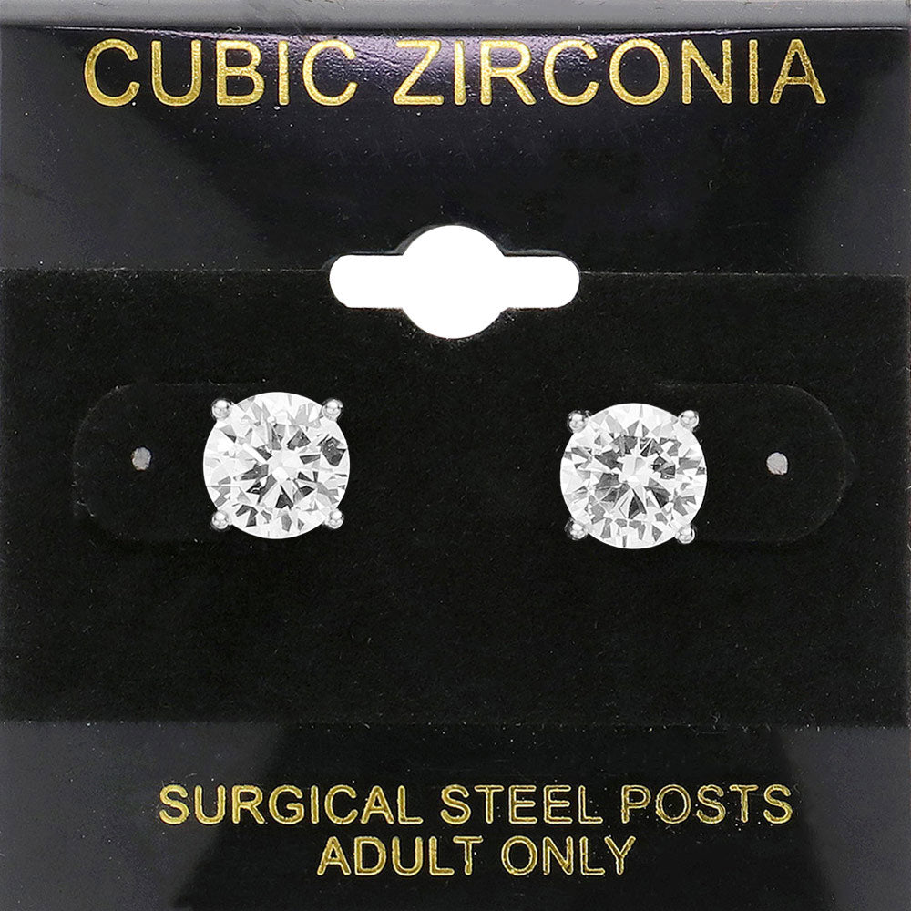 Classic round clear crystal stud earrings in a silver finish with prong settings and surgical steel posts, displayed on a black jewelry card.