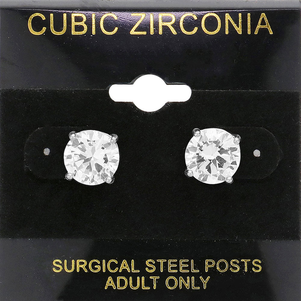 Classic round clear crystal stud earrings in a silver finish with prong settings and surgical steel posts, displayed on a black jewelry card.