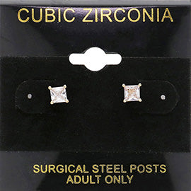 Classic square clear crystal stud earrings in a gold finish with four-prong settings and surgical steel posts, displayed on a black jewelry card.