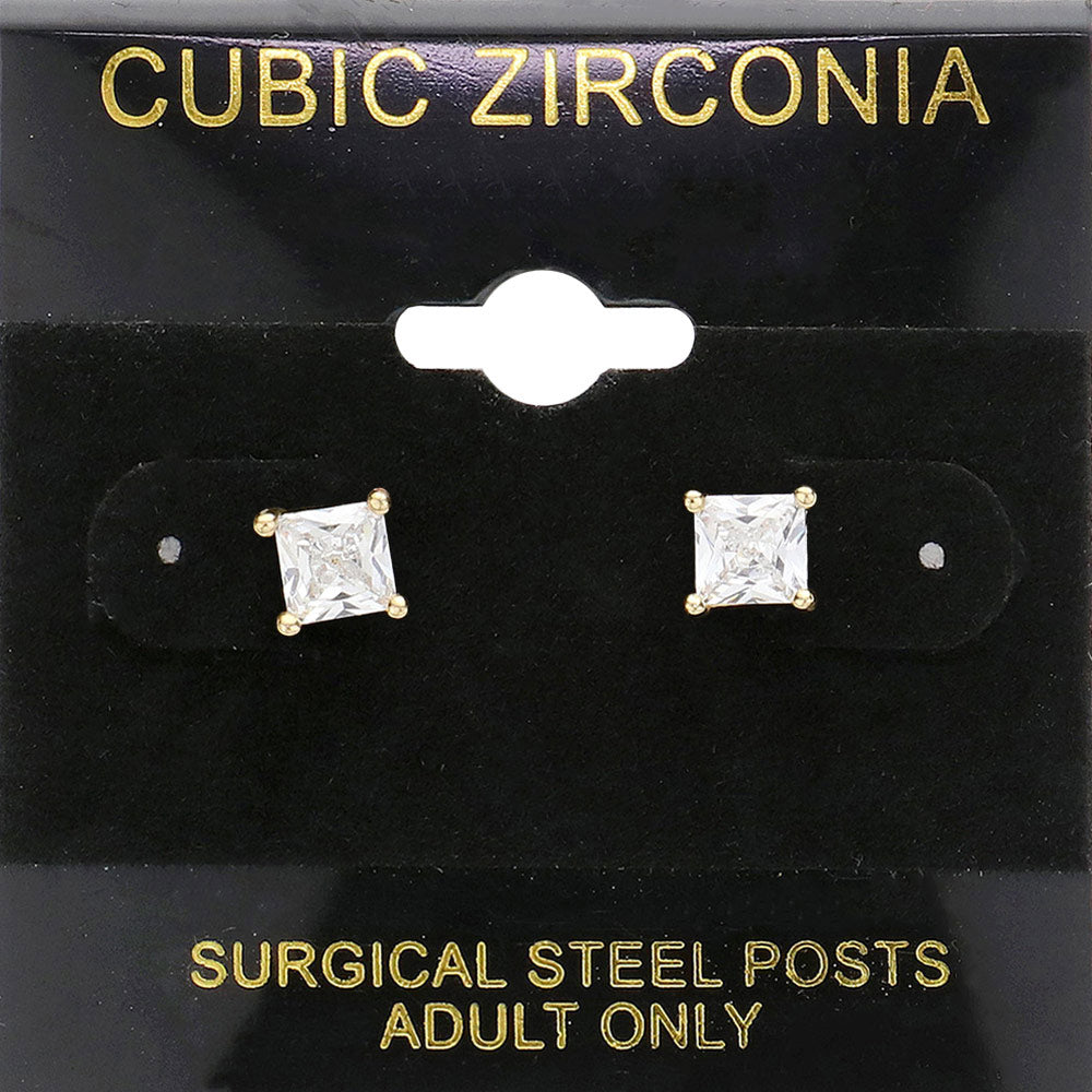Classic square clear crystal stud earrings in a gold finish with four-prong settings and surgical steel posts, displayed on a black jewelry card.