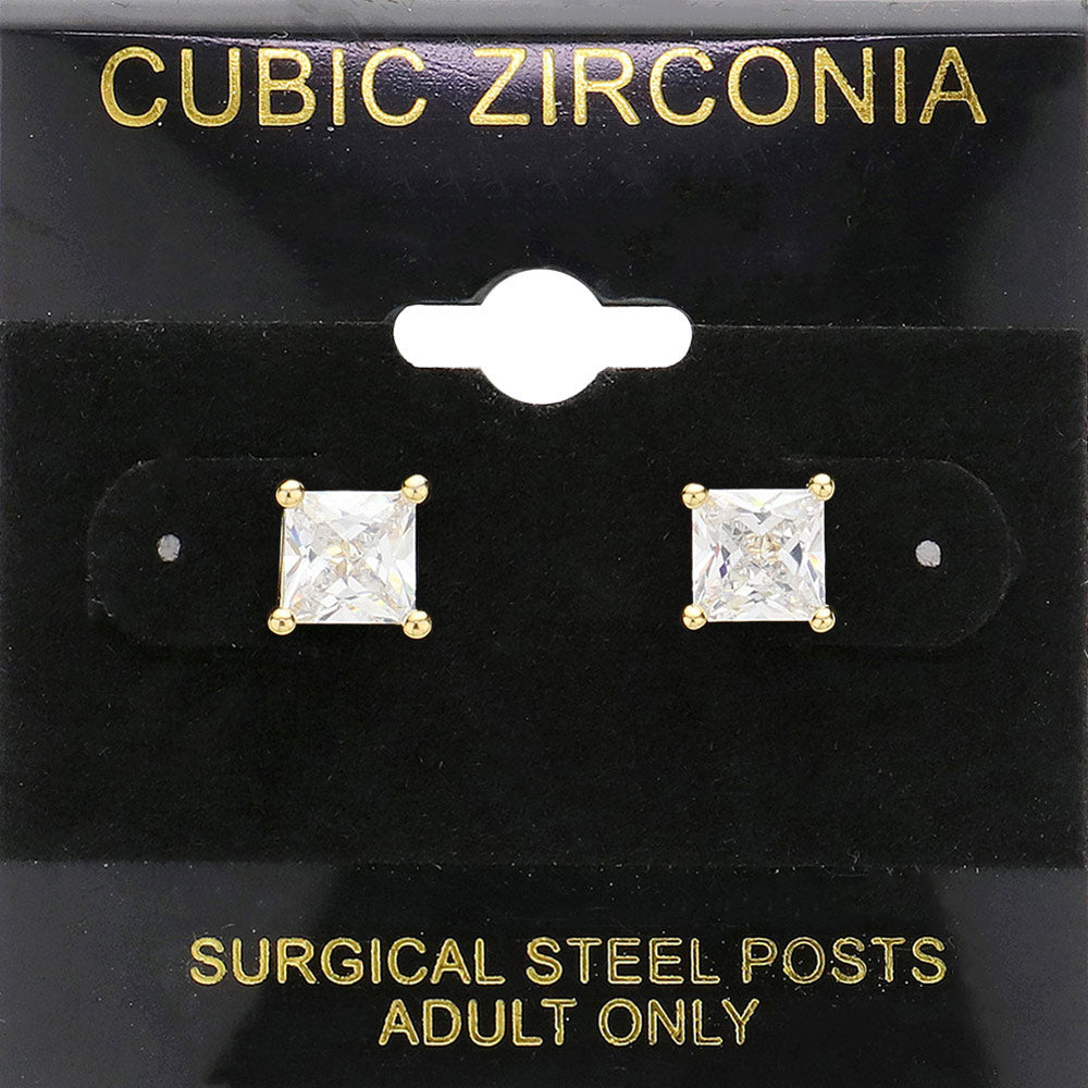 Classic square clear crystal stud earrings in a gold finish with four-prong settings and surgical steel posts, displayed on a black jewelry card.