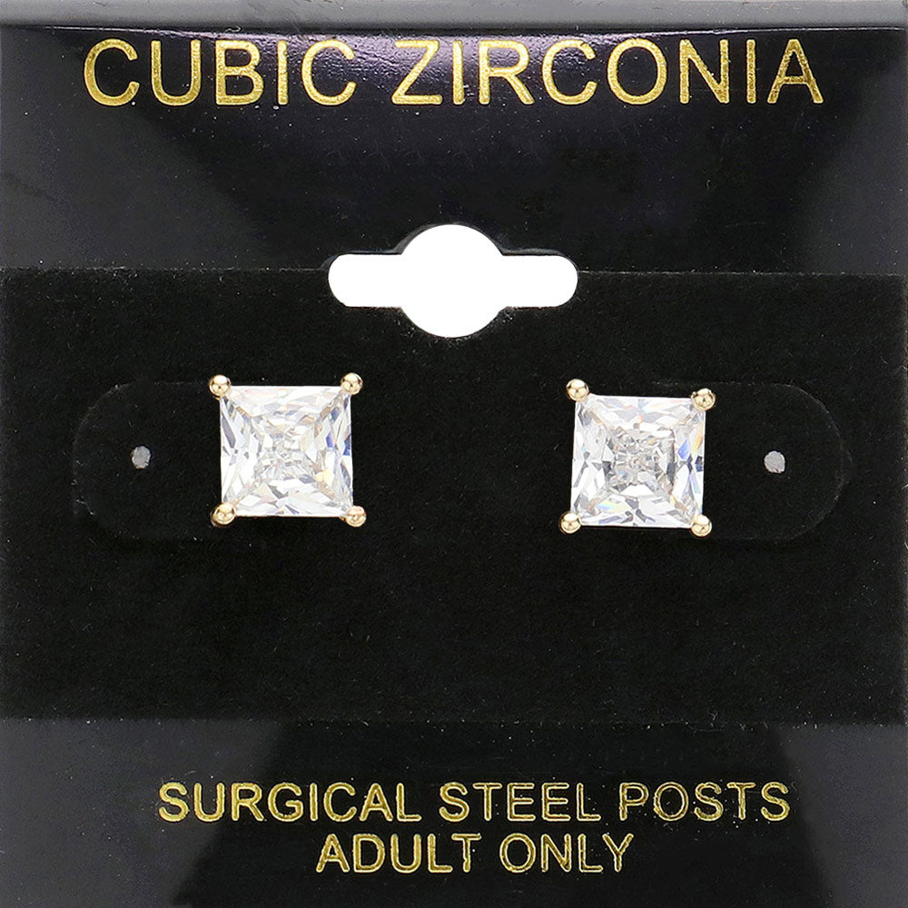 Classic square clear crystal stud earrings in a gold finish with four-prong settings and surgical steel posts, displayed on a black jewelry card.