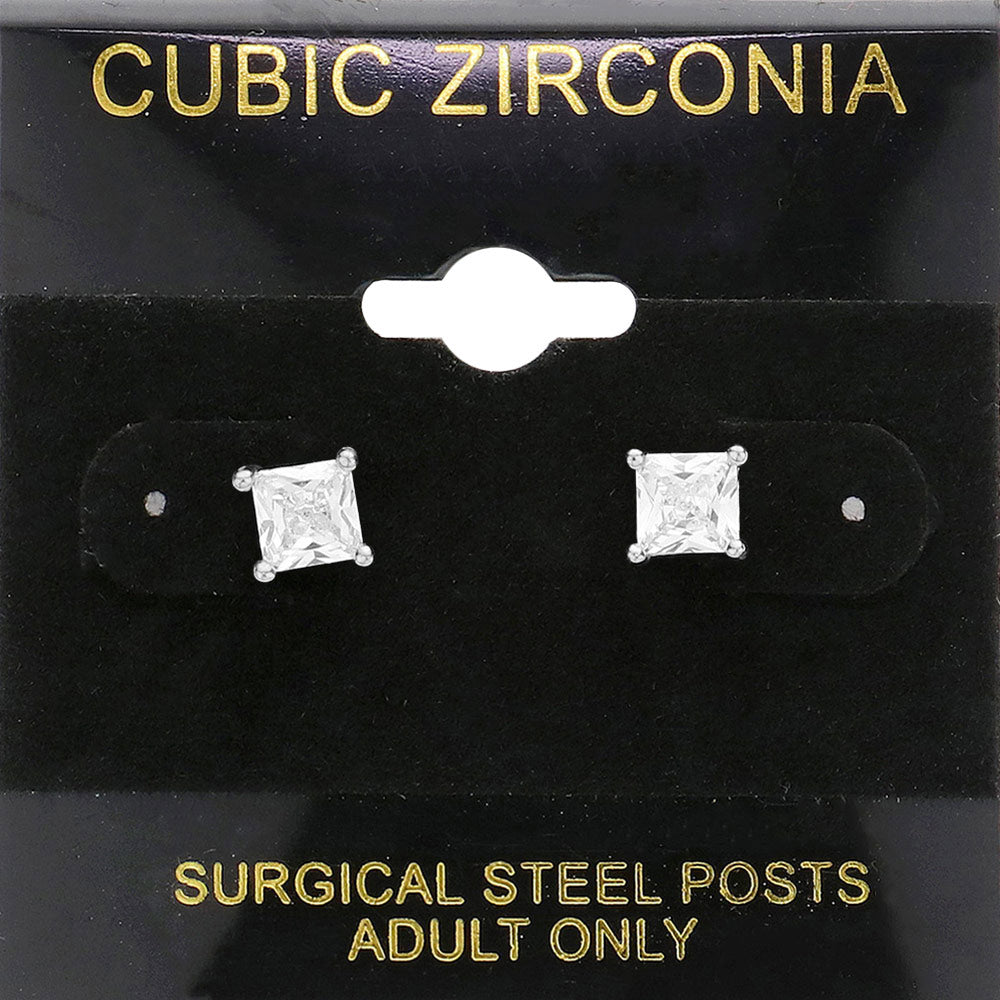 Classic square clear crystal stud earrings in a silver finish with four-prong settings and surgical steel posts, displayed on a black jewelry card.