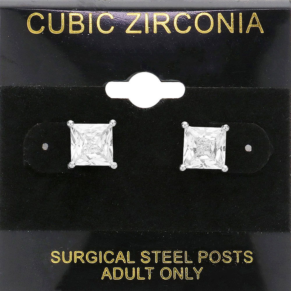 Classic square clear crystal stud earrings in a silver finish with four-prong settings and surgical steel posts, displayed on a black jewelry card.