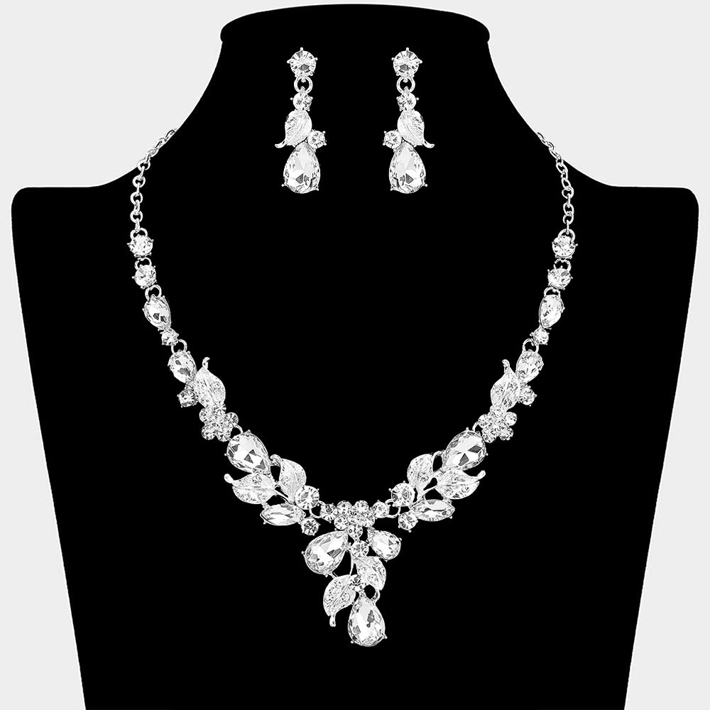 Clear teardrop leaf necklace set on silver with matching earrings for prom and evening wear on a black mannequin bust on a white background.