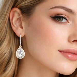 Clear teardrop rhinestone trim dangle earrings on gold worn on model