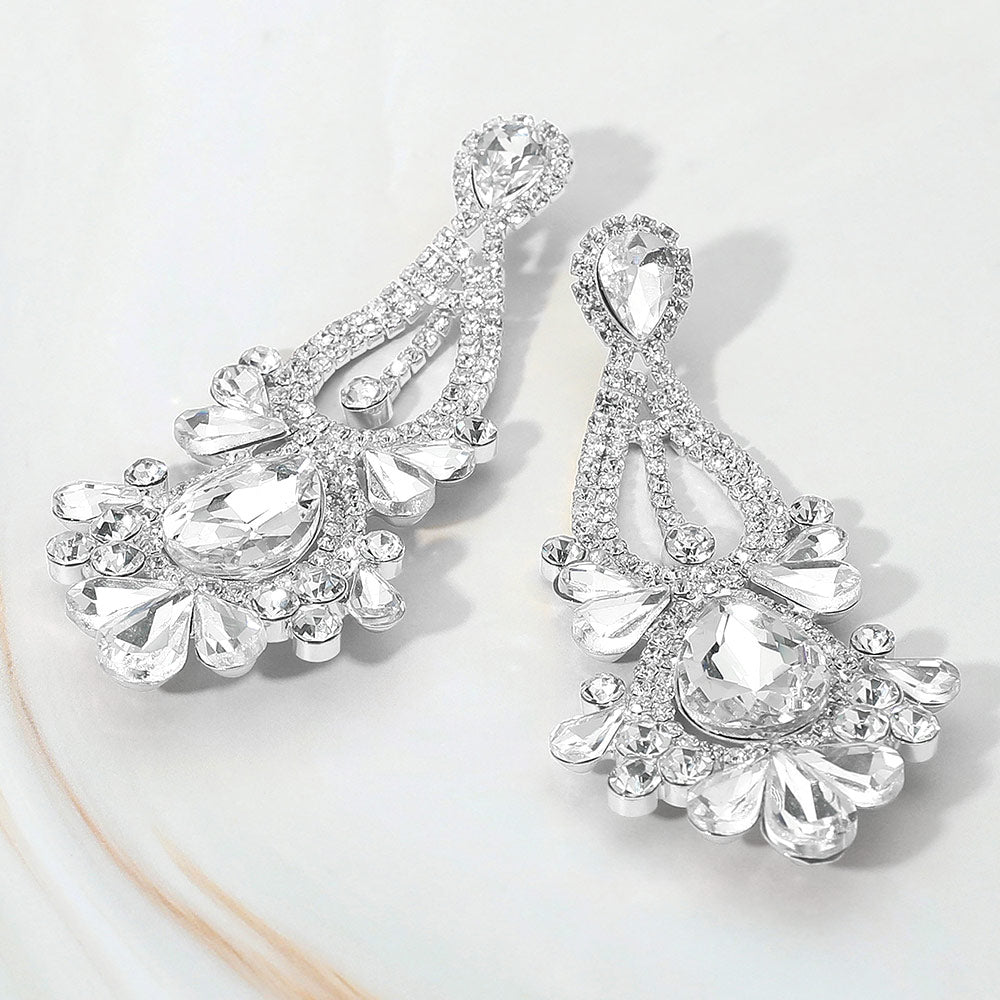Clear silver teardrop chandelier statement earrings with stone cluster design for prom, bridal, or evening wear on a white background.
