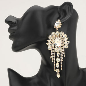 Long 4.6" clear crystal chandelier fringe earrings on gold on a black mannequin ear — dramatic crystal statement jewelry for pageant, prom, weddings, and evening events.