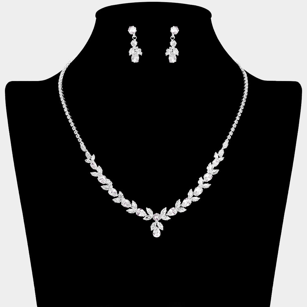 Clear crystal delicate necklace set on silver with alternating marquise stones, a small center drop, and matching drop earrings, displayed on a black jewelry bust.