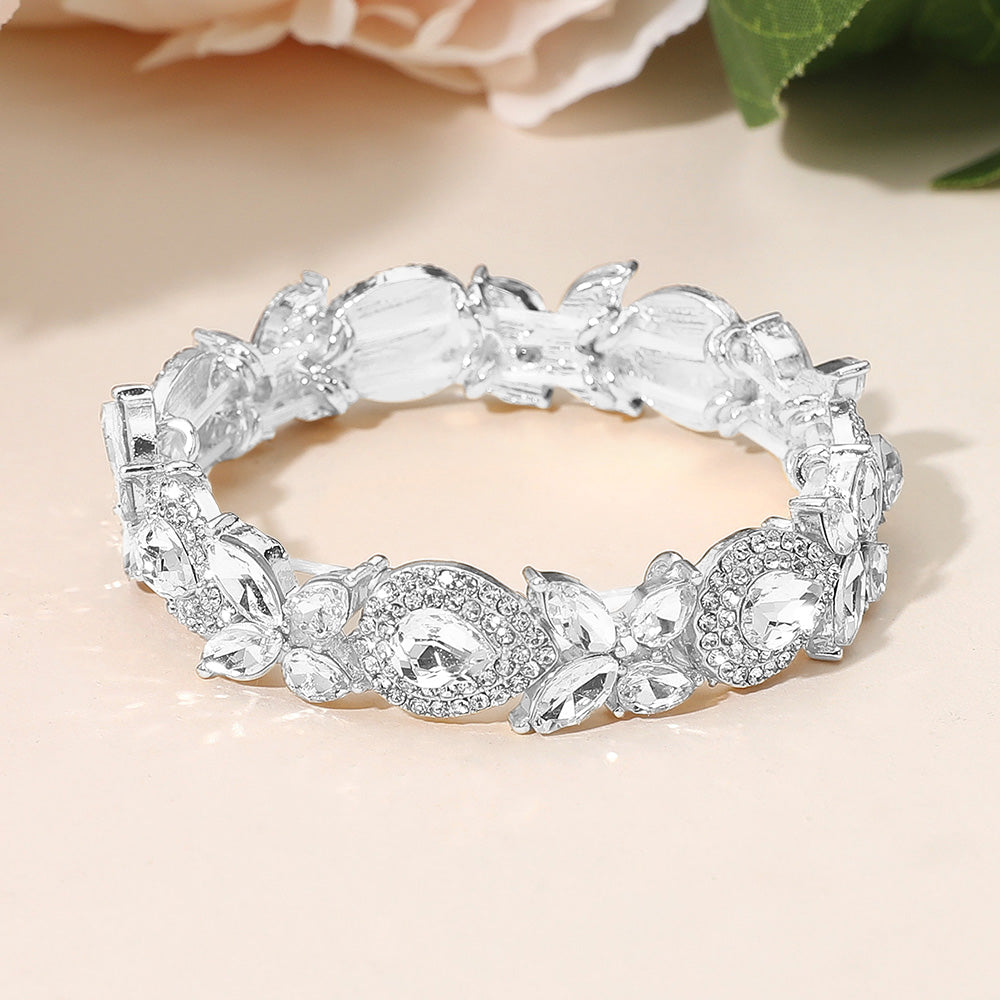 Clear rhinestone marquise stretch bracelet on silver for weddings and formal occasions on a peach background