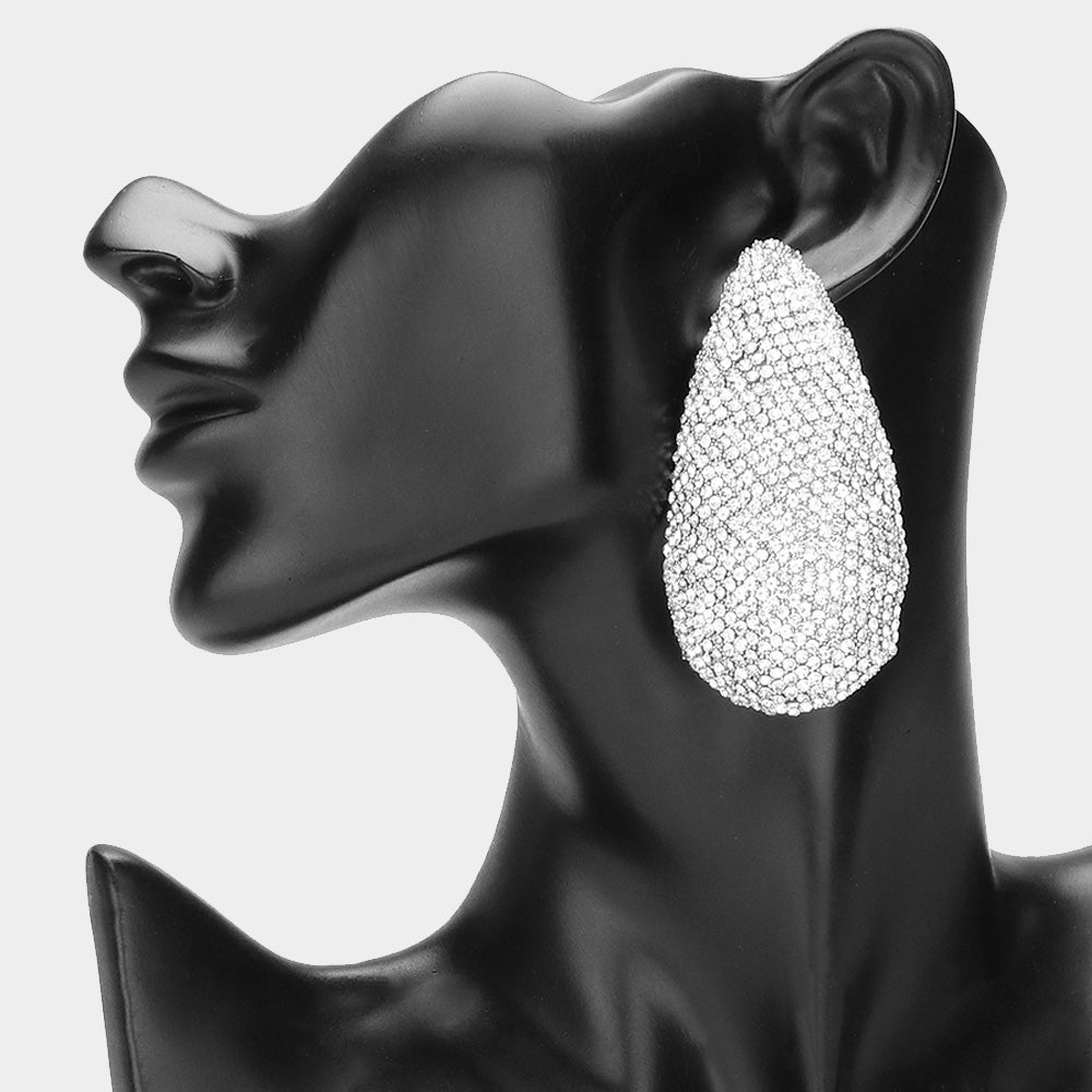 Clear crystal pavé teardrop statement earrings on silver covered in closely set round crystals, displayed on a black mannequin.