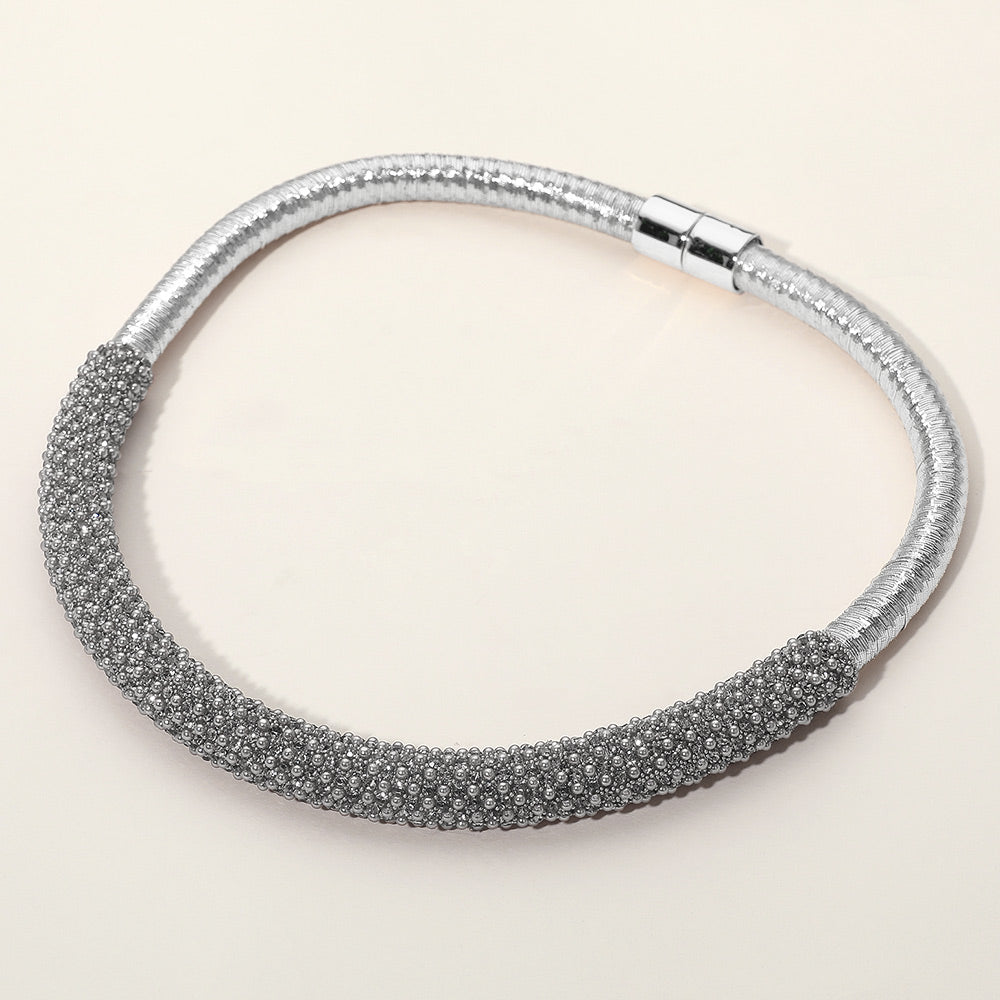 Clear crystal beaded magnetic choker necklace on silver with a textured crystal-beaded front section, displayed on a light beige background.
