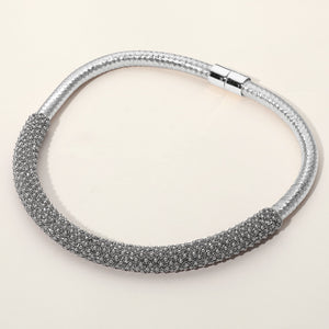 Clear crystal beaded magnetic choker necklace on silver with a textured crystal-beaded front section, displayed on a light beige background.