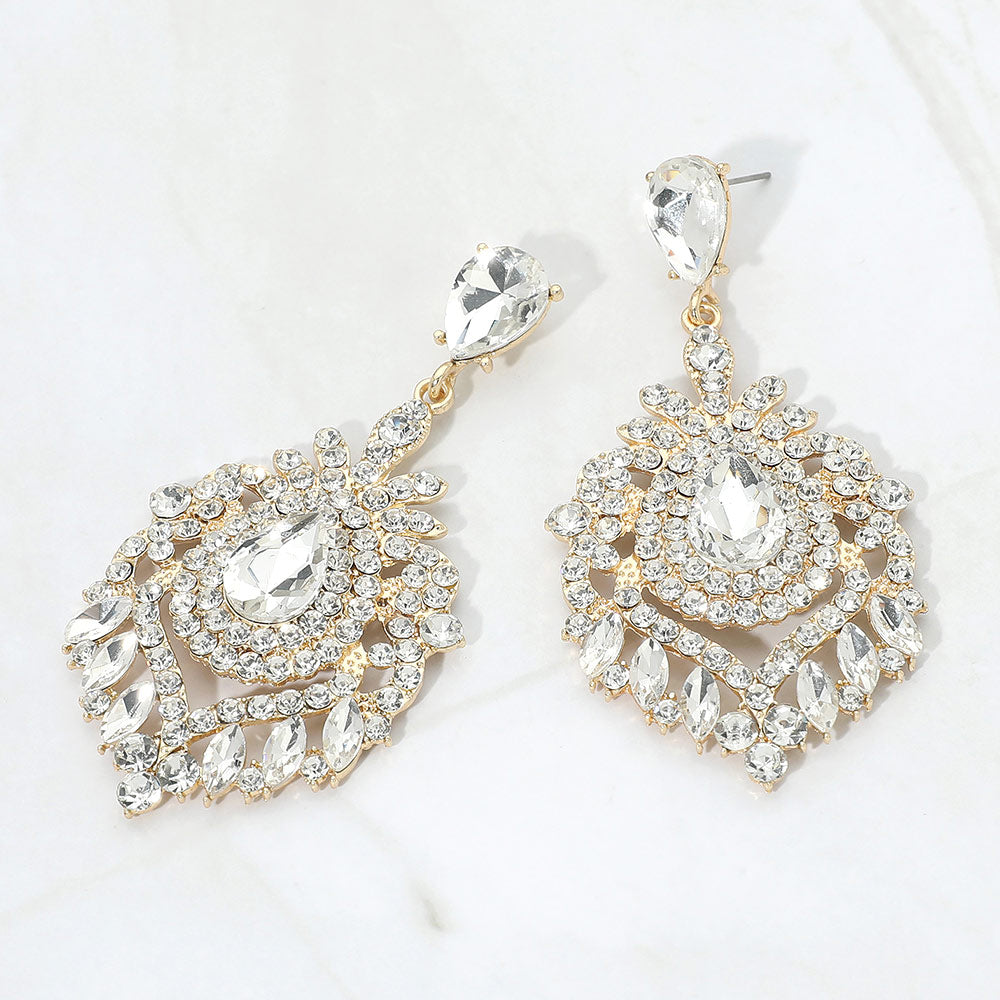 Clear crystal teardrop chandelier statement pageant earrings on gold with an ornate layered crystal design, displayed on a white background.