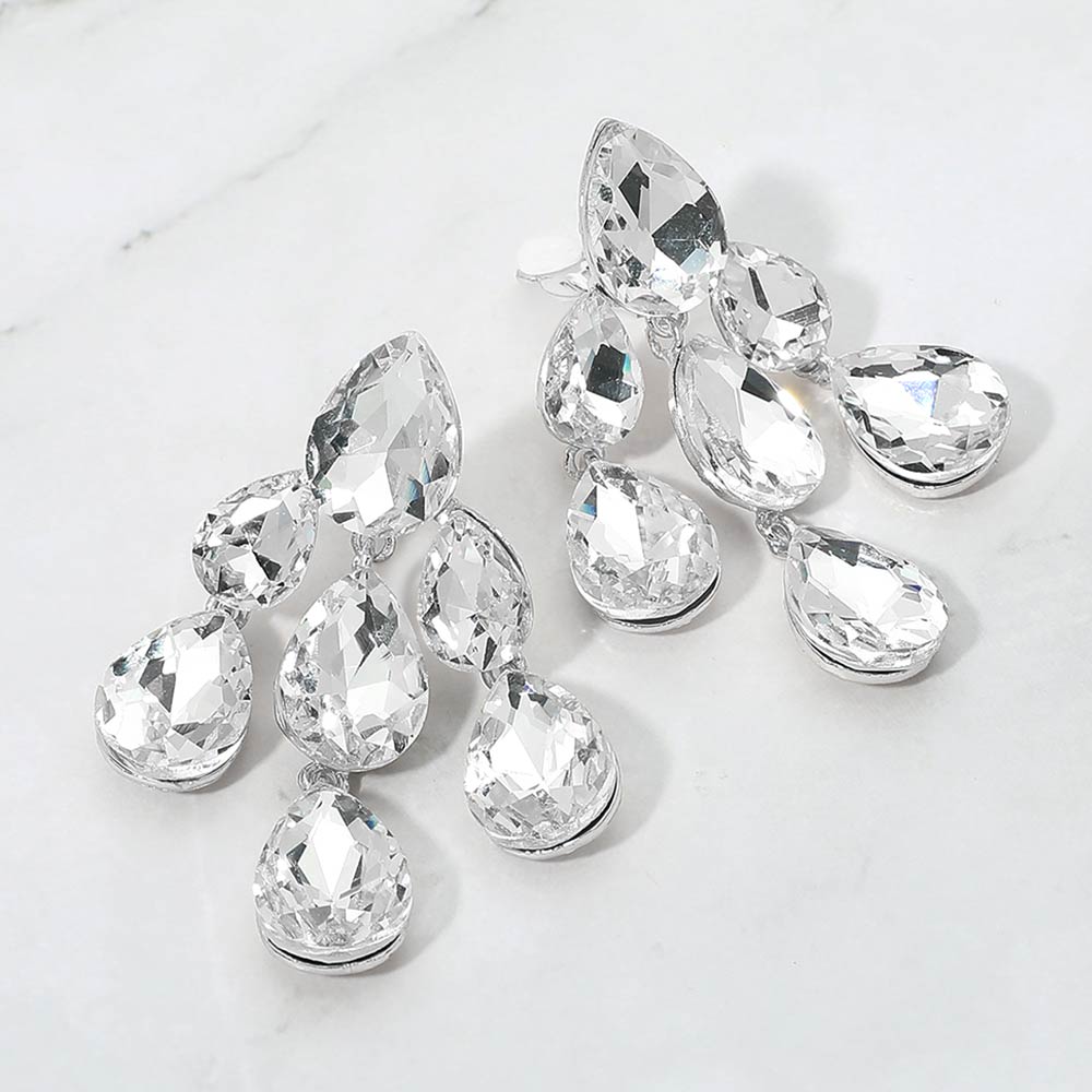 Clear crystal teardrop cluster chandelier clip-on earrings on silver on white marble background