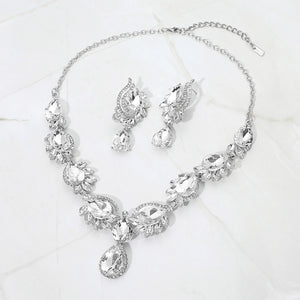 Clear crystal teardrop formal necklace and matching earrings set on silver displayed on a white background.