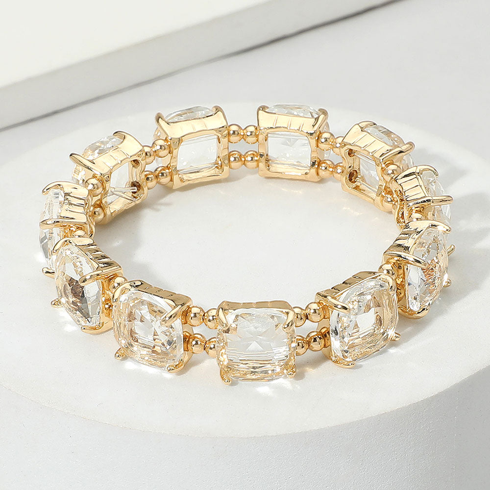 Clear cushion square stone stretch evening bracelet on gold, classic crystal bracelet on a white background