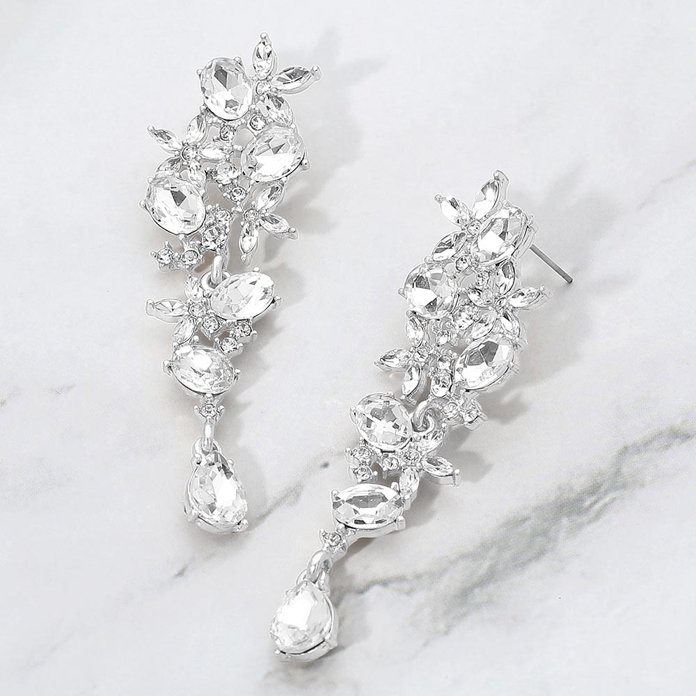 Clear on silver floral gem cluster drop earrings with marquise and oval stones for everyday or evening elegance on a marble background 