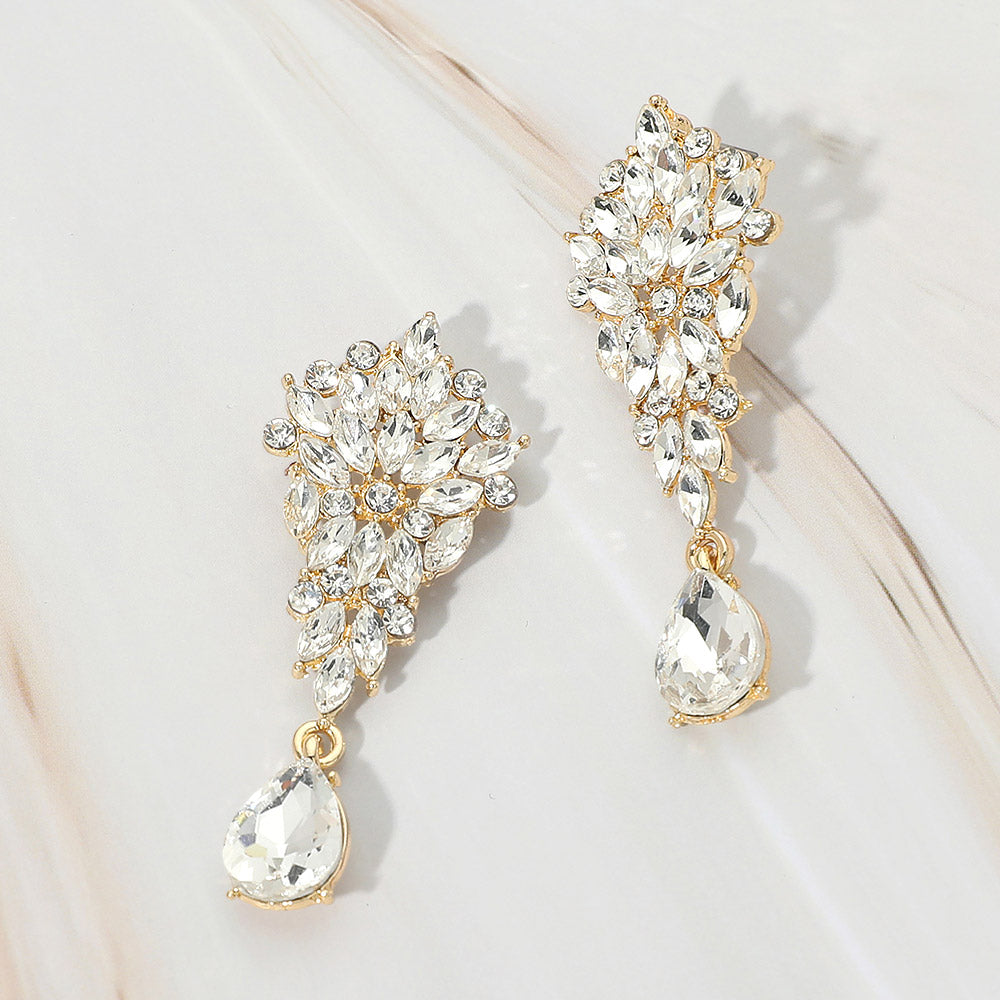 Clear floral marquise cluster teardrop drop earrings on gold on white marble background