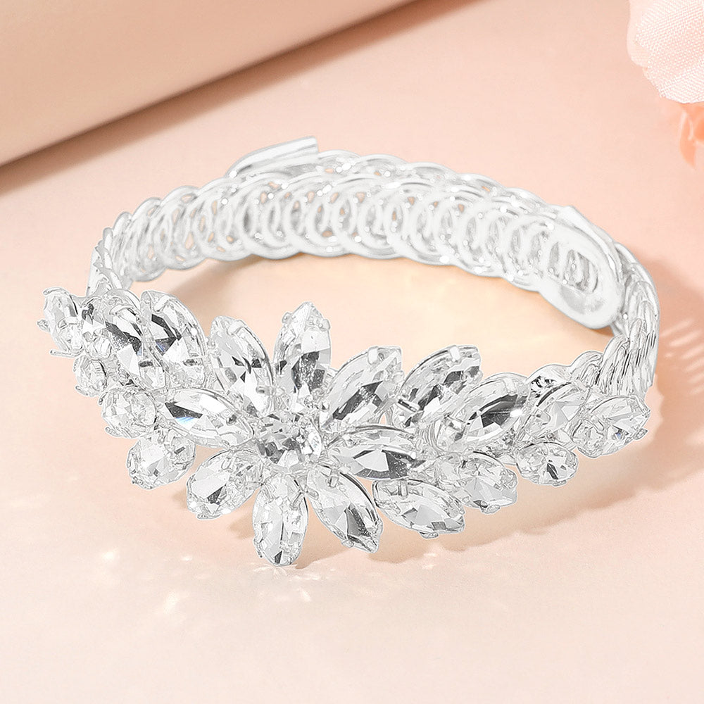 Clear crystal floral marquise adjustable bracelet on silver displayed on a beige background.